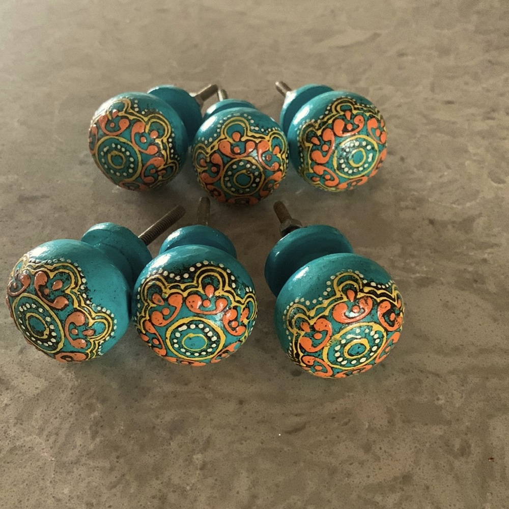 6 drawer / cabinet knobs in teal with yellow and orange detail.